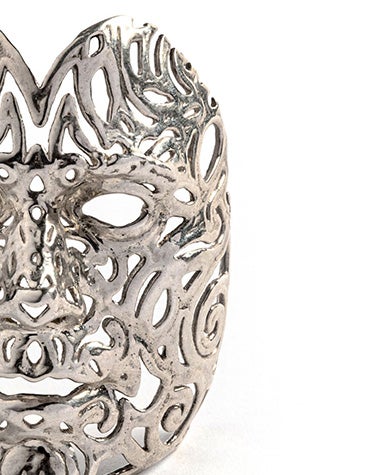 An intricate silver face mask made with lost-wax casting.
