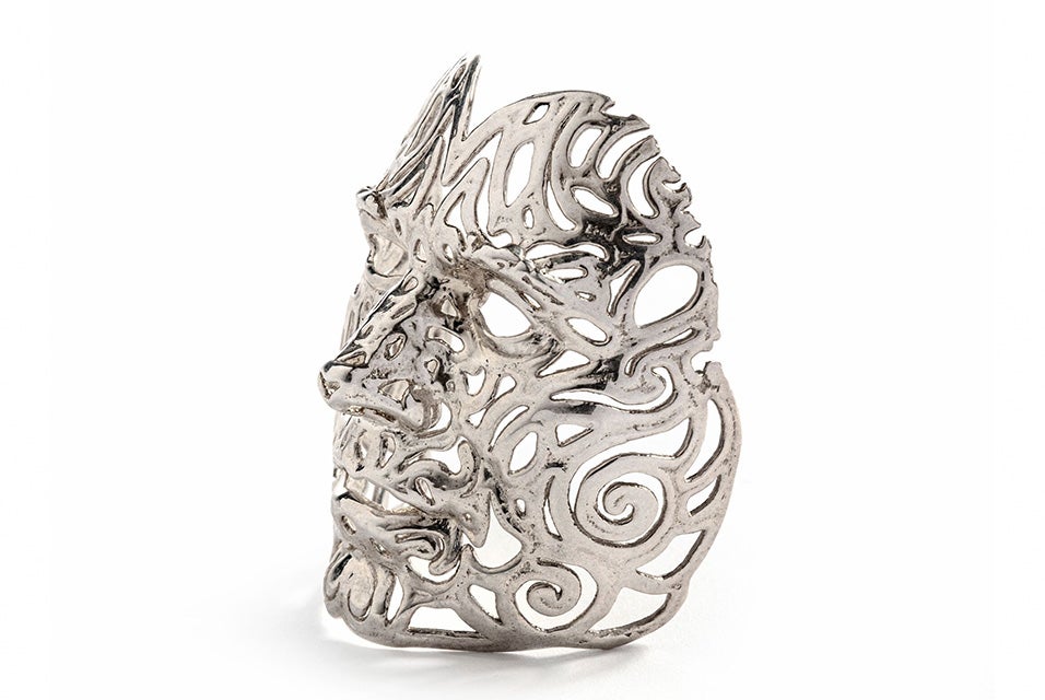 An intricate silver face mask made with lost-wax casting.