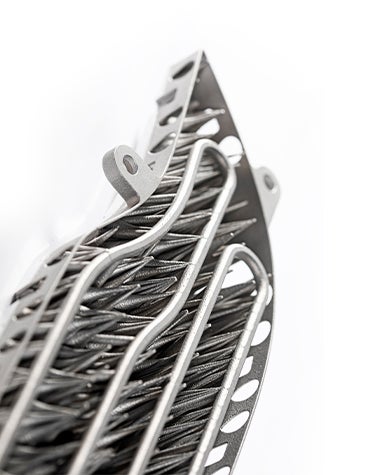 Underside of a 3D-printed metal lamination tool with cooling channels for automotive use