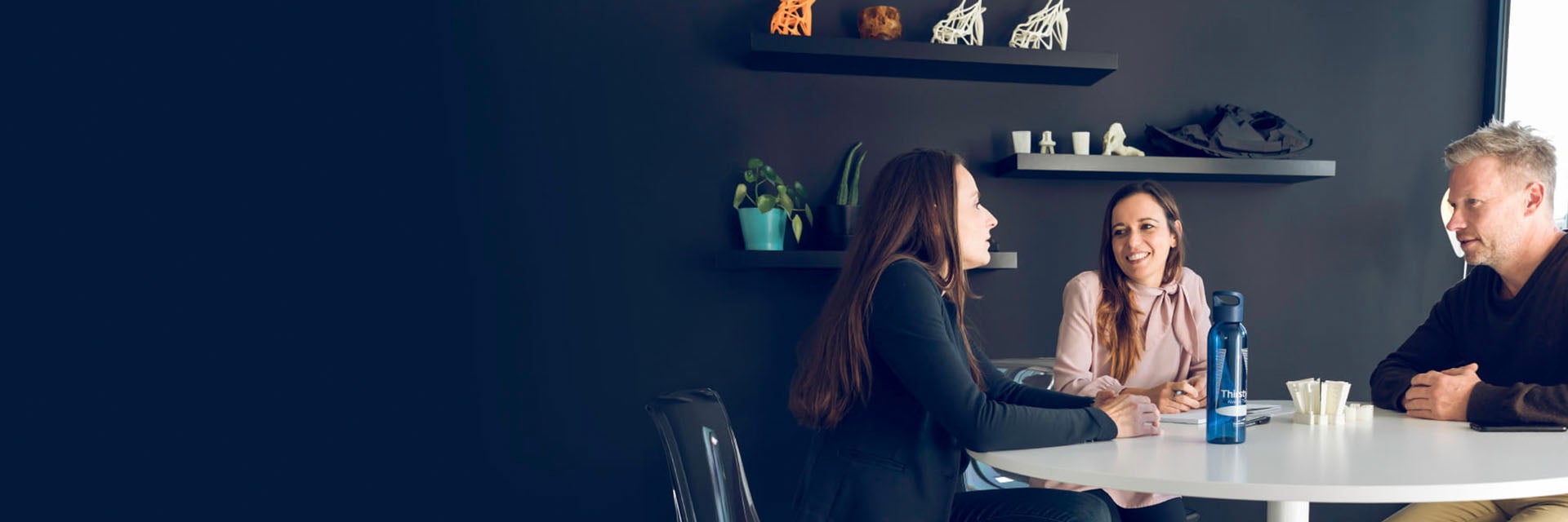 Group of people sitting at a table and talking