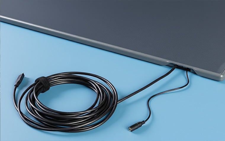 A shot of the Materialise Footscan Pro Level pressure plate's connection options, with two cords sticking out of the side of the plate.