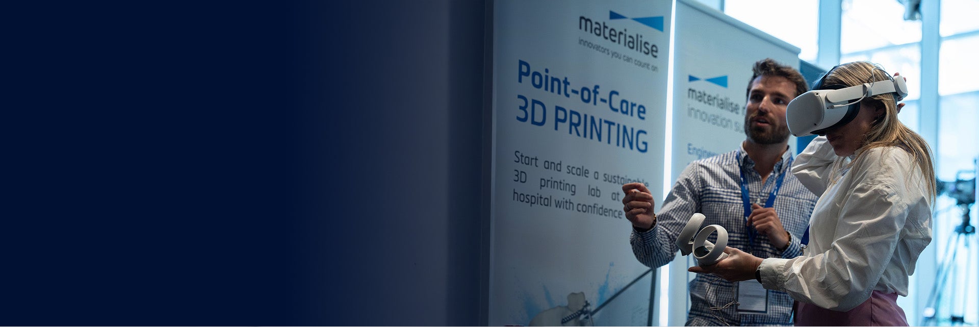 A man assisting a woman wearing a VR headset at a point-of-care 3D printing event