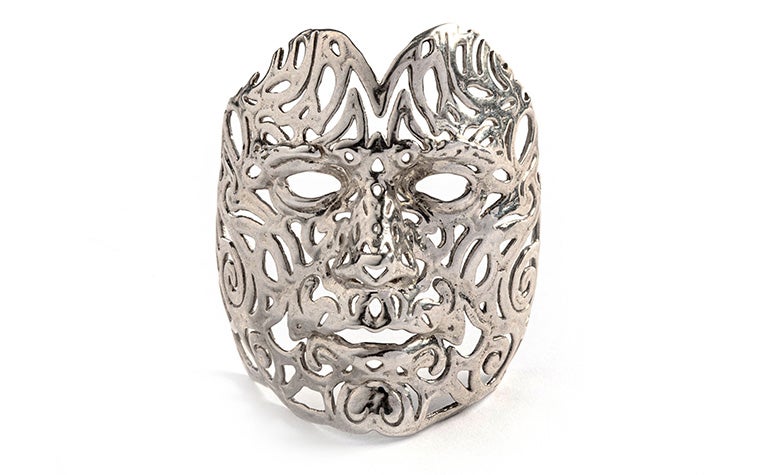 An intricate silver face mask made with lost-wax casting.