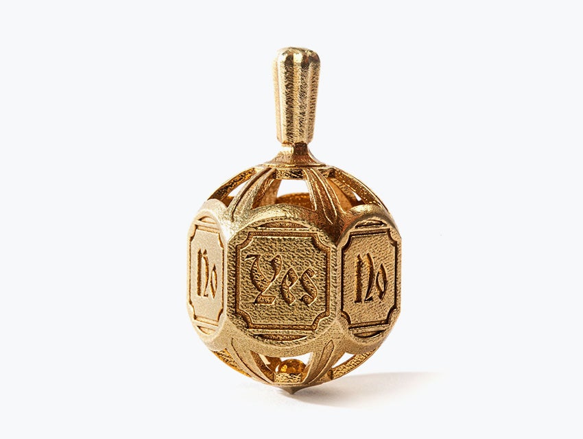 A detailed decision-making spinning top embossed with the words "yes" and "no". Made in brass using lost-wax casting.