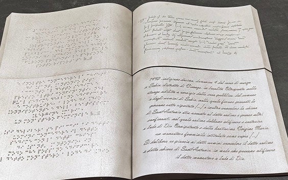 3D-printed replica of an ancient book with braille on one side