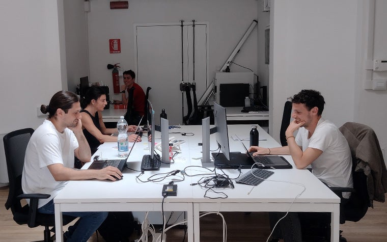 Engineering team at their computers in the office of the eDIMES Lab at the University of Bologna