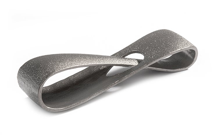 A metal 3D-printed infinity loop made from titanium using selective laser melting. The loop has a satin finish, achieved through glass bead blasting.