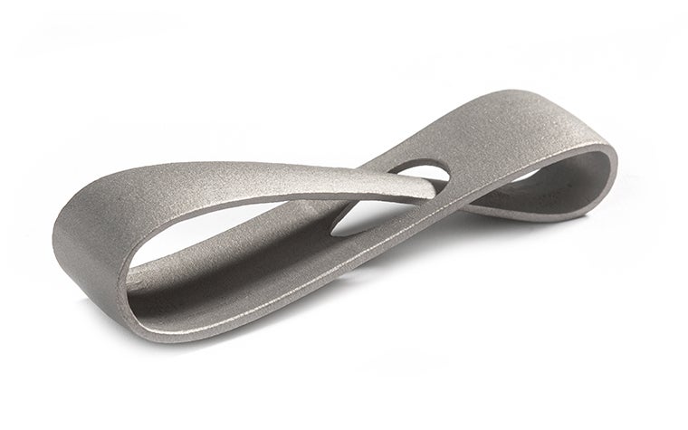 A metal 3D-printed infinity loop made from inconel using selective laser melting. The loop has a smooth, matt finish, achieved through post-machining.