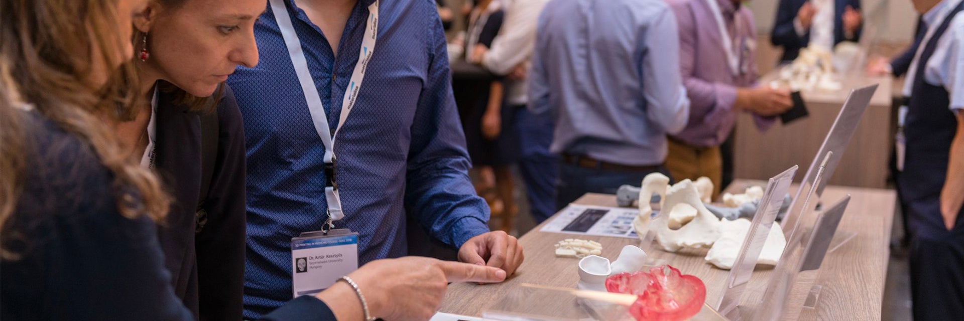 3D printing in medicine course attendees looking at a display of 3D-printed anatomical models 