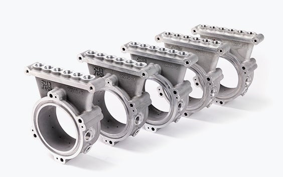 Una fila di cinque anelli di iniezione in alluminio stampato in 3D, realizzati per la tecnologia di combustione a idrogeno a doppia alimentazione di CMB.TECH.