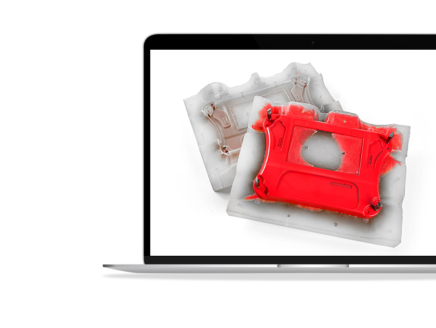 A laptop screen showing a red vacuum-cast housing on top of its silicone mold.