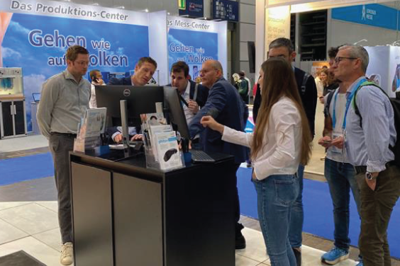 Annouk Verluyten and a group of clinicians talking at a booth in a foot health event.