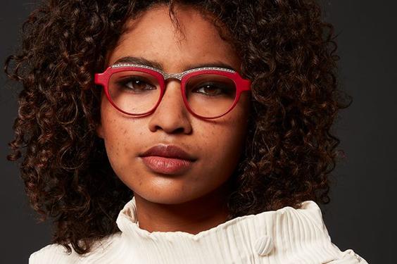 Black female model wearing red eyewear