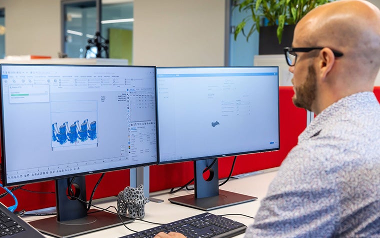 Man using nester software and CO-AM software on his computer