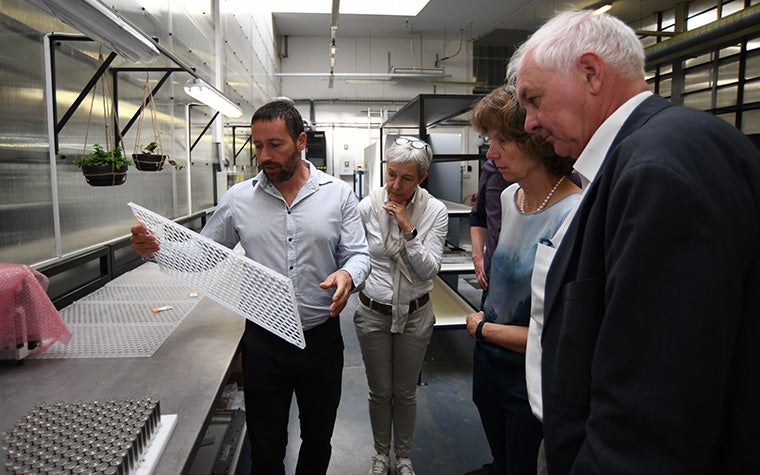 CEO Brigitte de Vet, Board Chairman Fried Vancraen, and Executive Vice President Hilde Ingelaere looking at a finished part in Materialise's Czech Republic facilities.