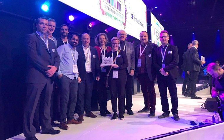 Materialise employees posing with the ‘Factory of the Future 4.0’ trophy