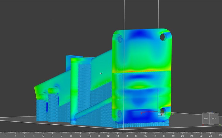 The heat signature of a 3D model being analyzed in the Ansys Simulation module. The model is a combination of green and blue while the supports are blue.