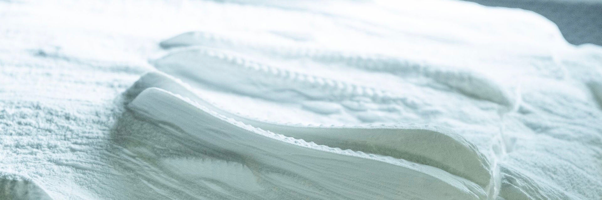 Custom orthotics in a bed of 3D printing powder