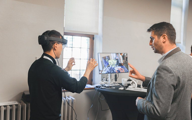 Two 3D Printing in Hospital Forum 2023 attendees trying AR