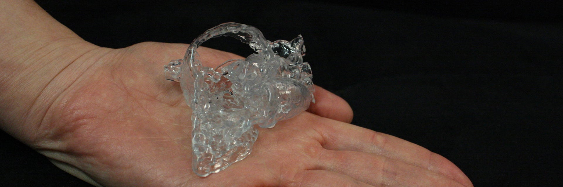 3D-printed heart model sitting in the palm of a hand 