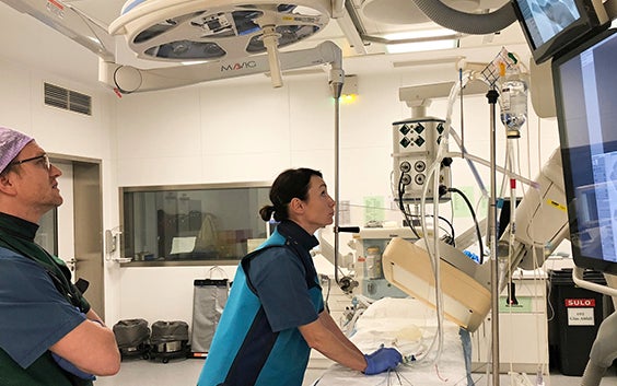 Surgeon in the OR training with a catheter using a 3D-printed heart