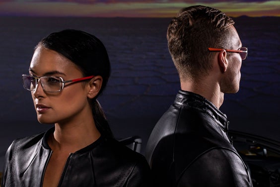 Two models standing wearing 3D-printed sunglasses from the McClaren Vision Collection