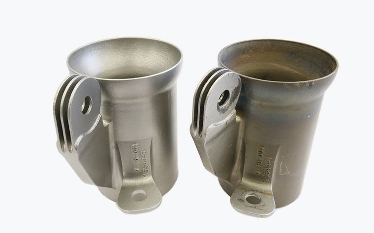 Two metal muffler couplers for powered gliders. One produced with traditional manufacturing methods, one metal 3D-printed in Inconel by Vocus.