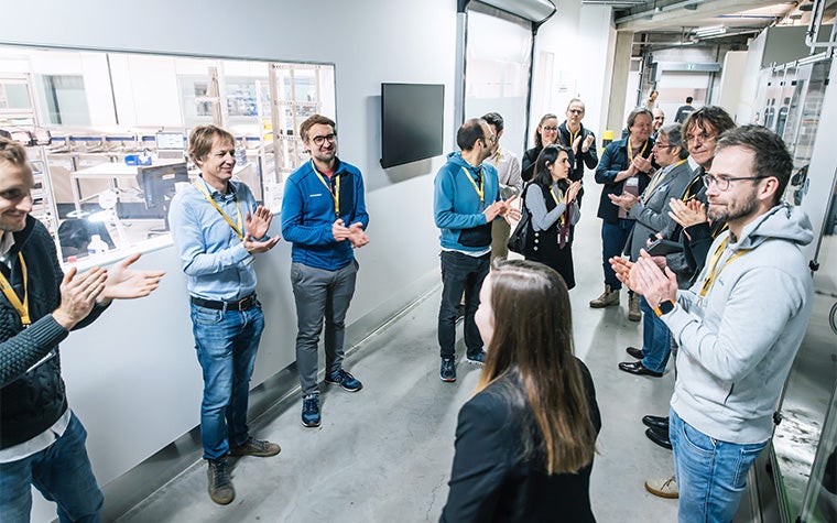 Group of CMF Experience Day attendees clapping at Materialise HQ