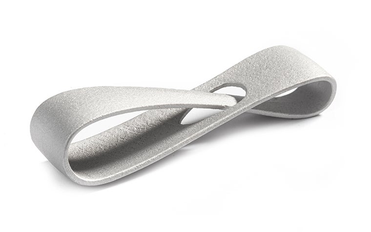 A metal 3D-printed infinity loop made from aluminum using selective laser melting. The loop has a matt finish, achieved through post-machining. 
