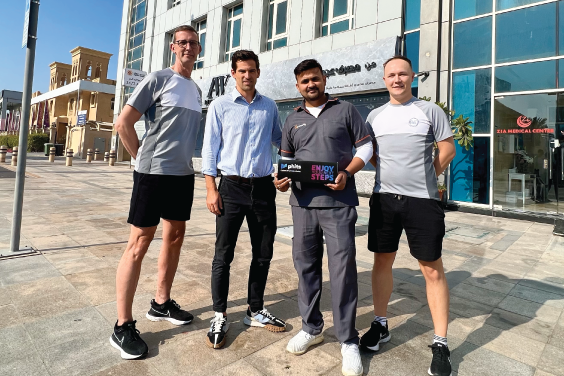 Four men from Gait and Motion Technology holding a box of phits orthotics in front of clinic in the UAE.