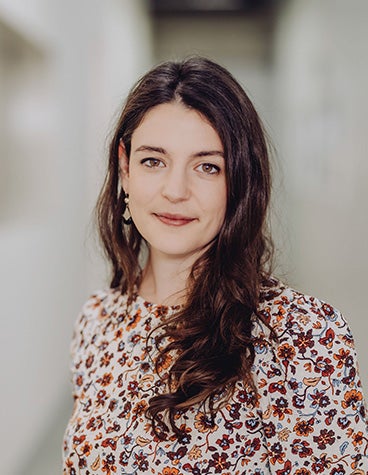 A female Materialise employee smiling and looking into the camera