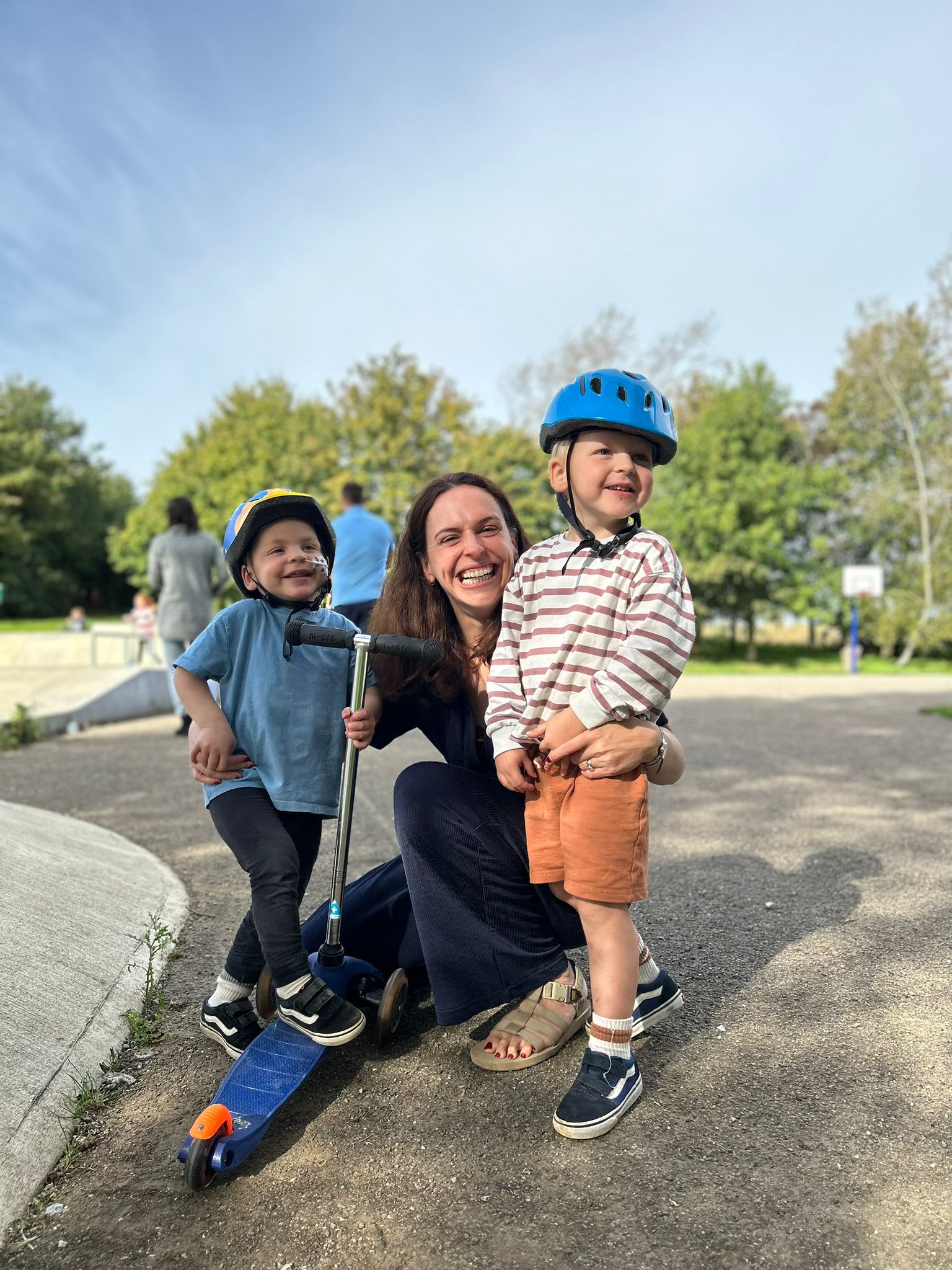 Jo Hughes with her sons smiling at the park