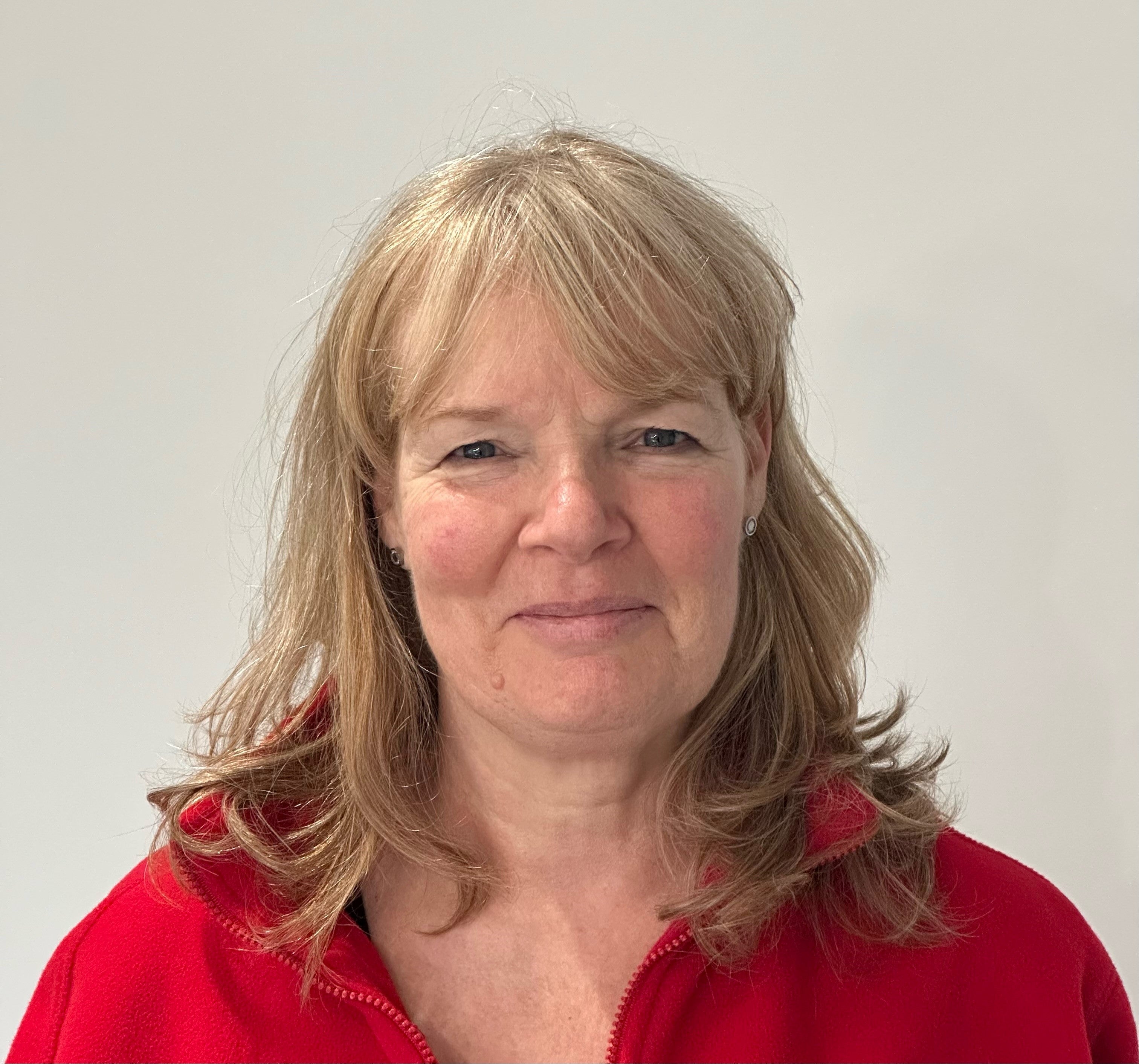 Elderly white blond woman in a red sweatshirt