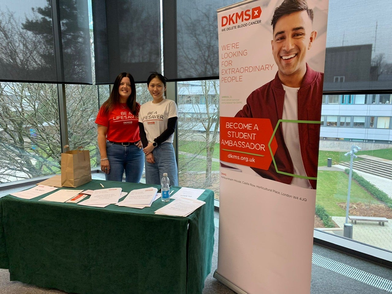 Two volunteers at the Stirling University hub smiling together 