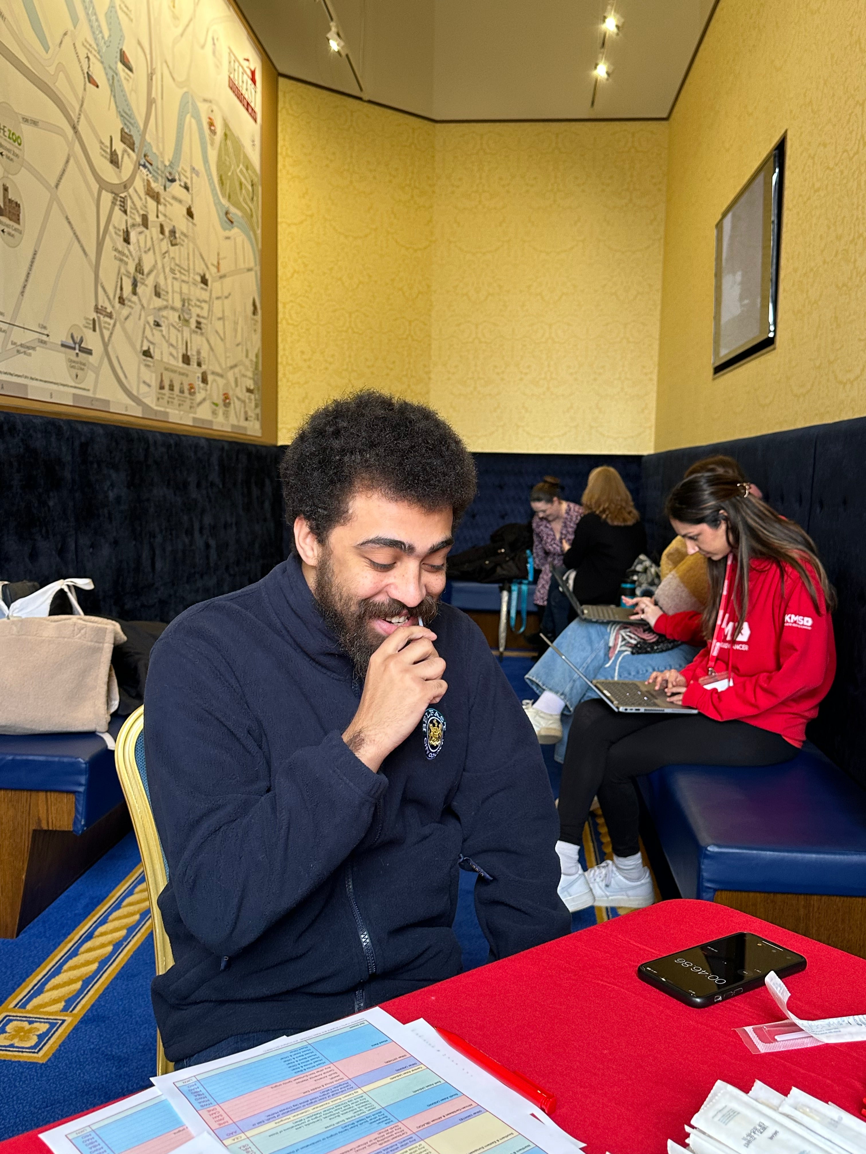 Man smiling and swabbing at DKMS event