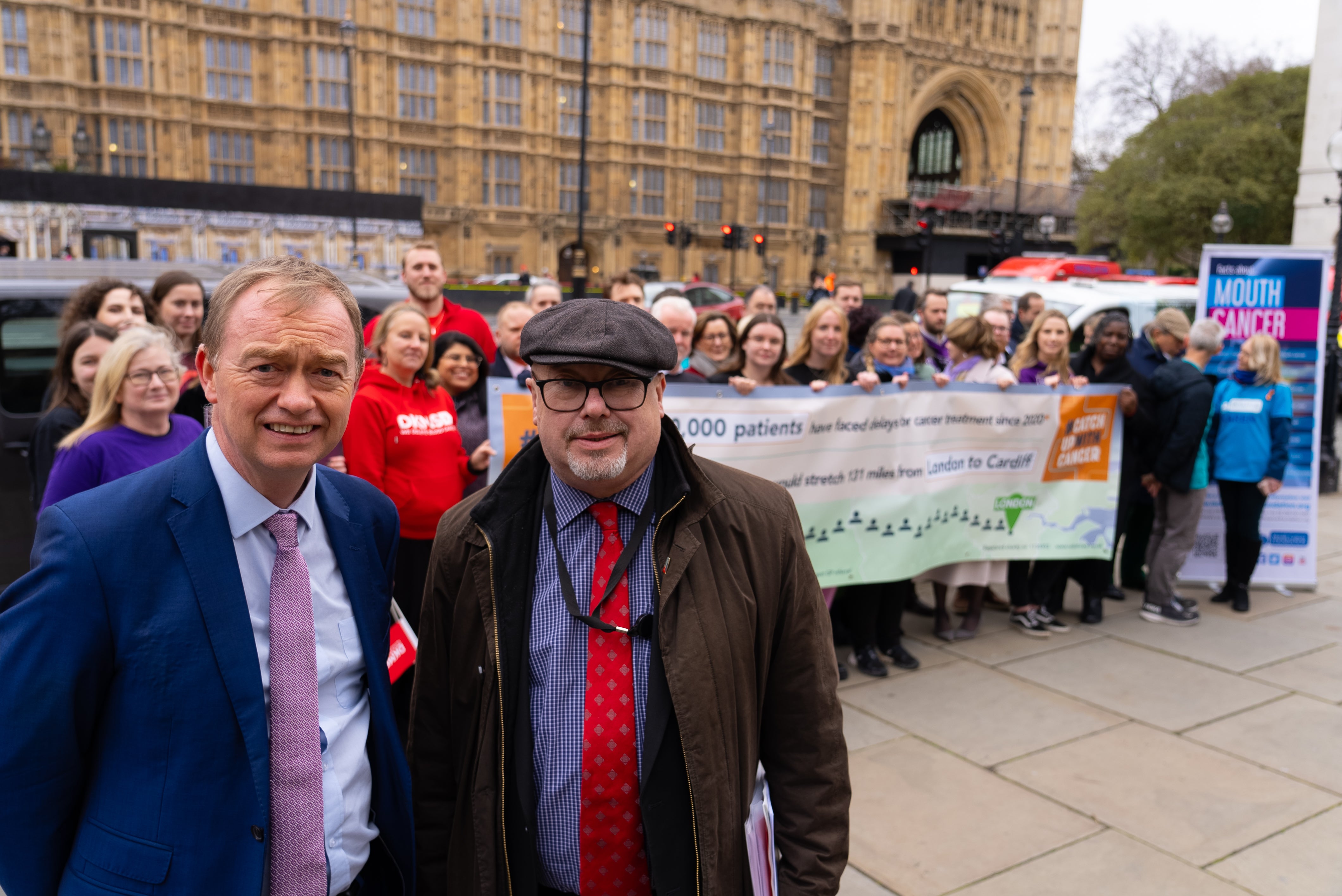 Two officials smiling at the camera at the catch up to cancer event