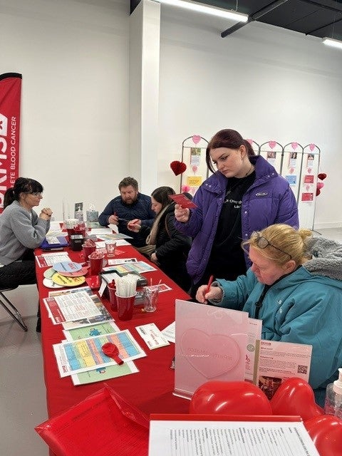 People registering at a DKMS drive event