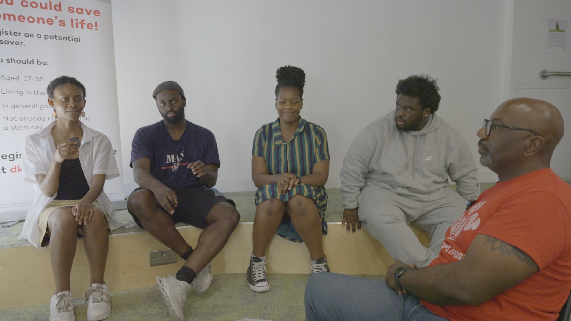 Five Africans sitting together chatting