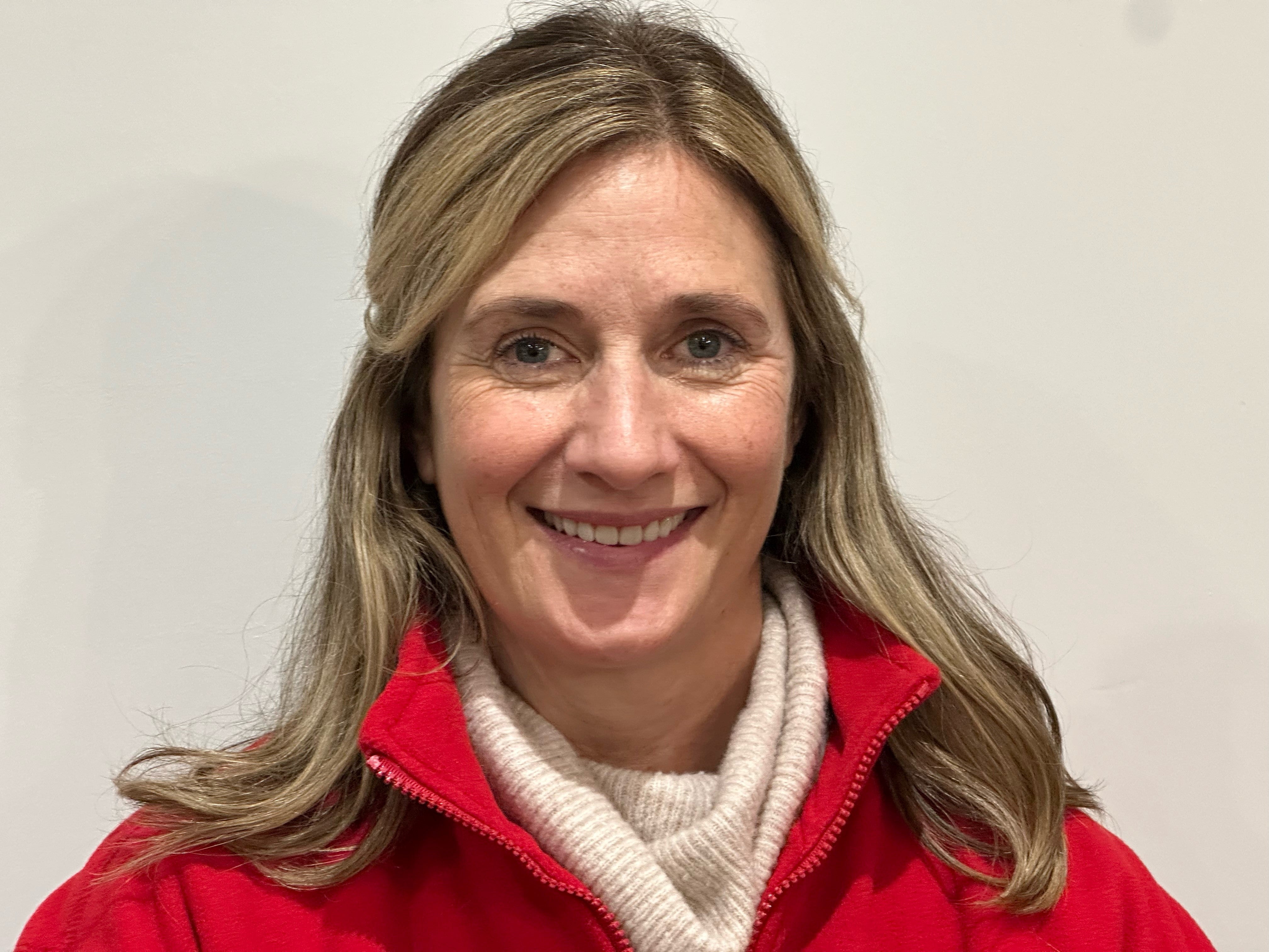 Middle aged white woman in a red sweatshirt 