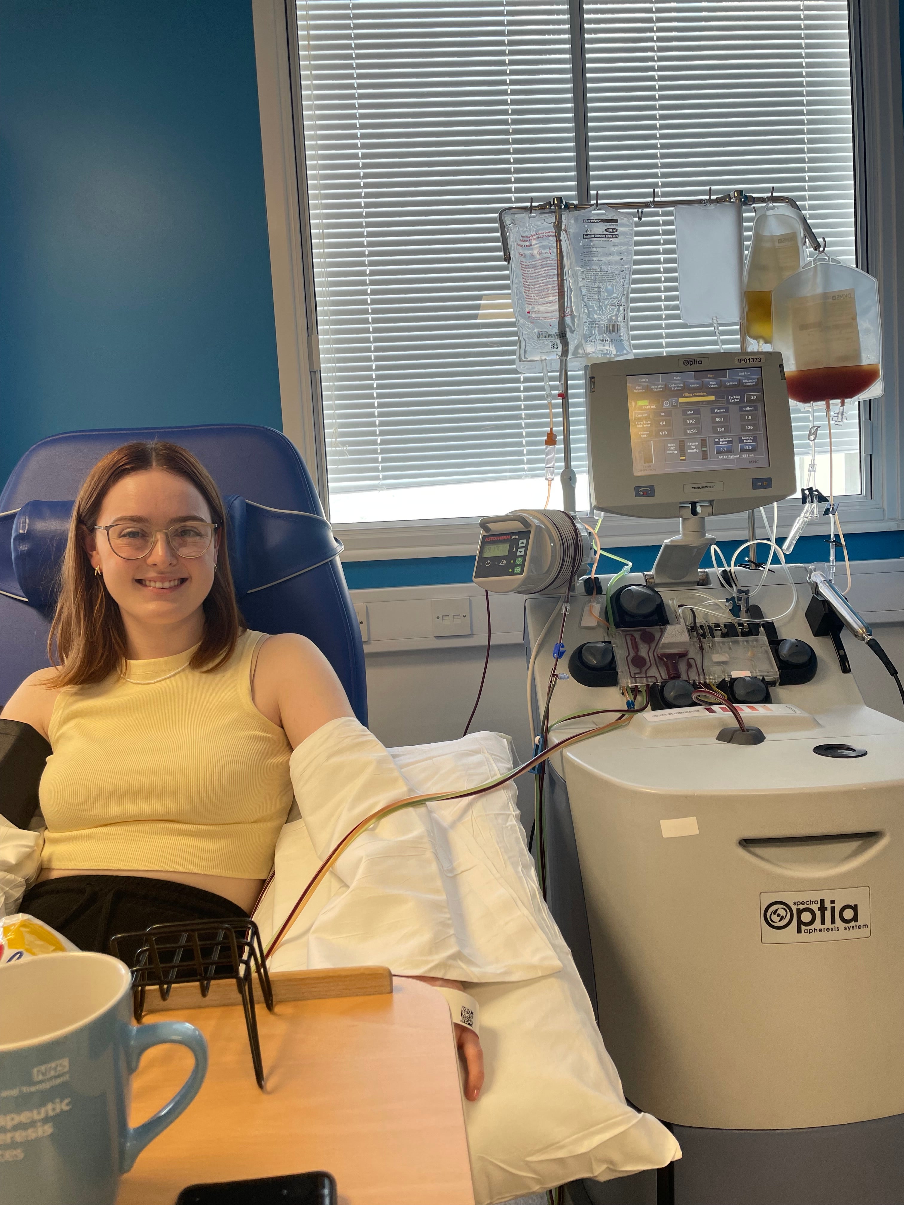 Lady on a hospital bed holding a bag of stem cells