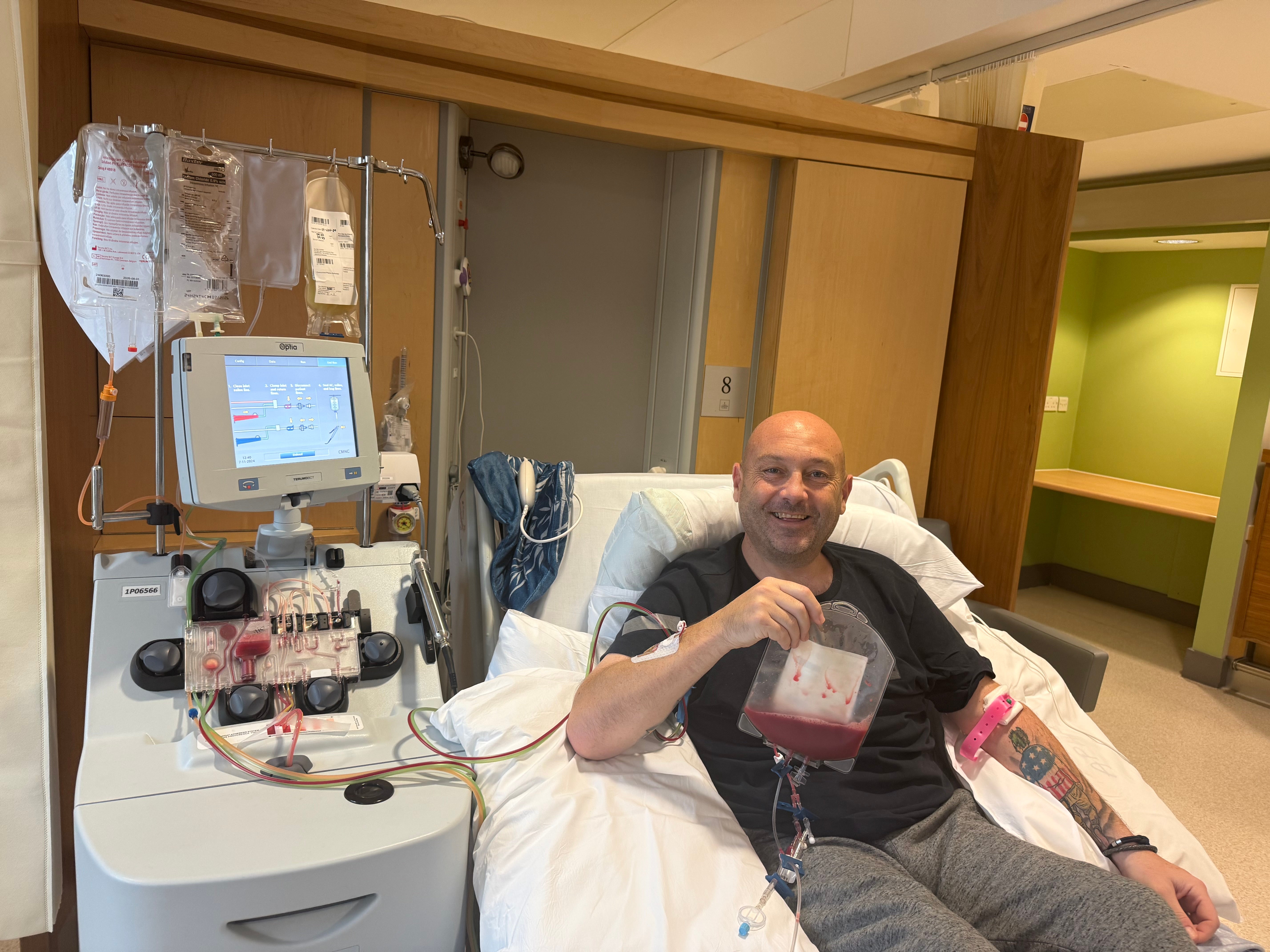 Elderly man at the hospital holding a bag of stem cells