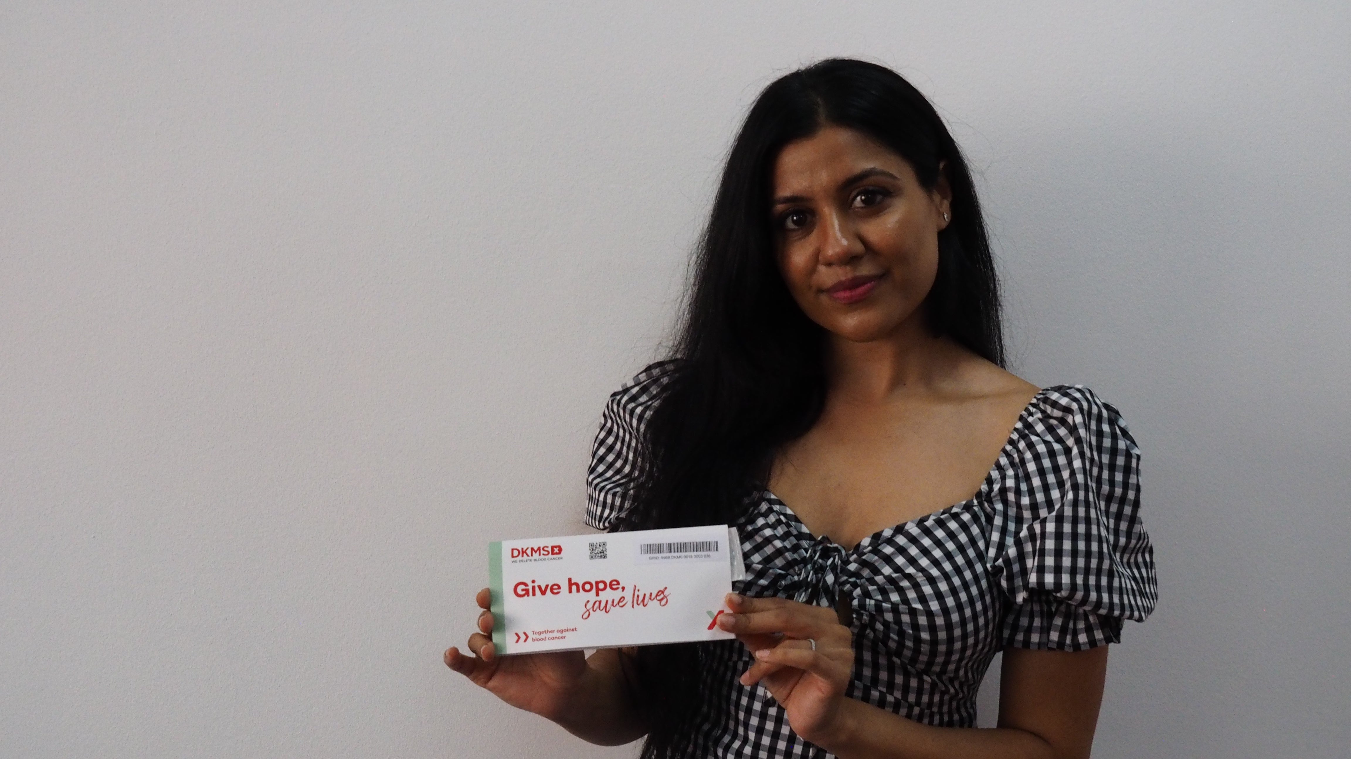 Priya holding a swab kit