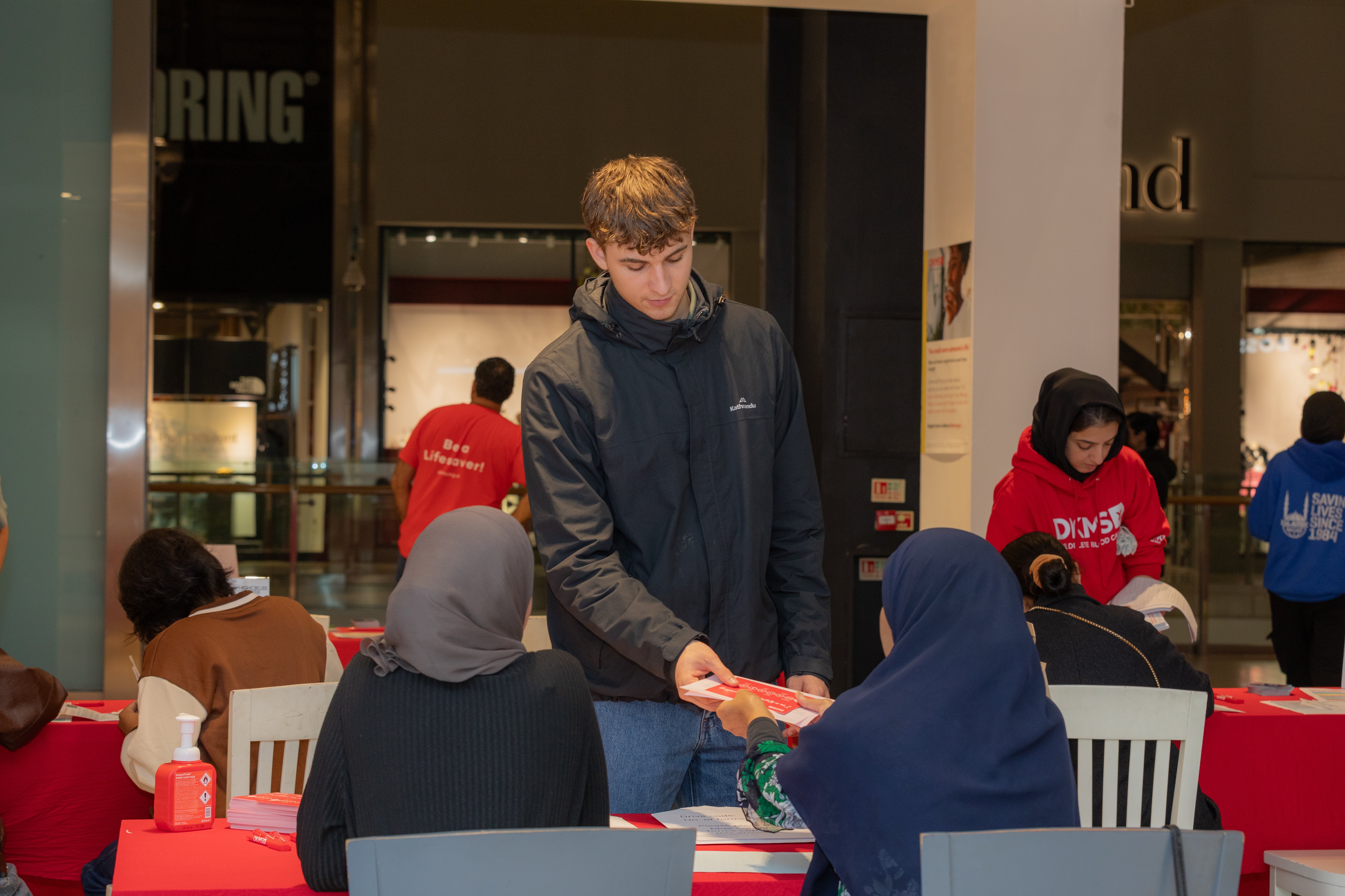 Two women in hijabs swabbing