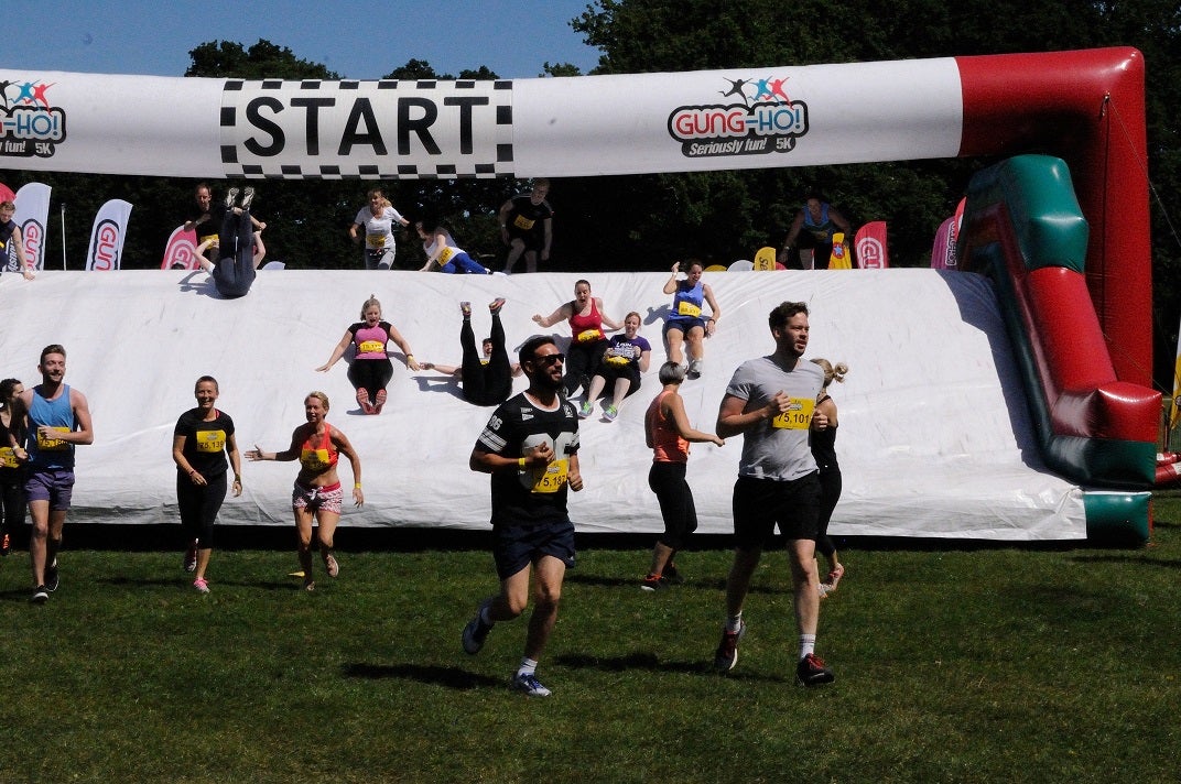 Runners at an inflatable obstacle course