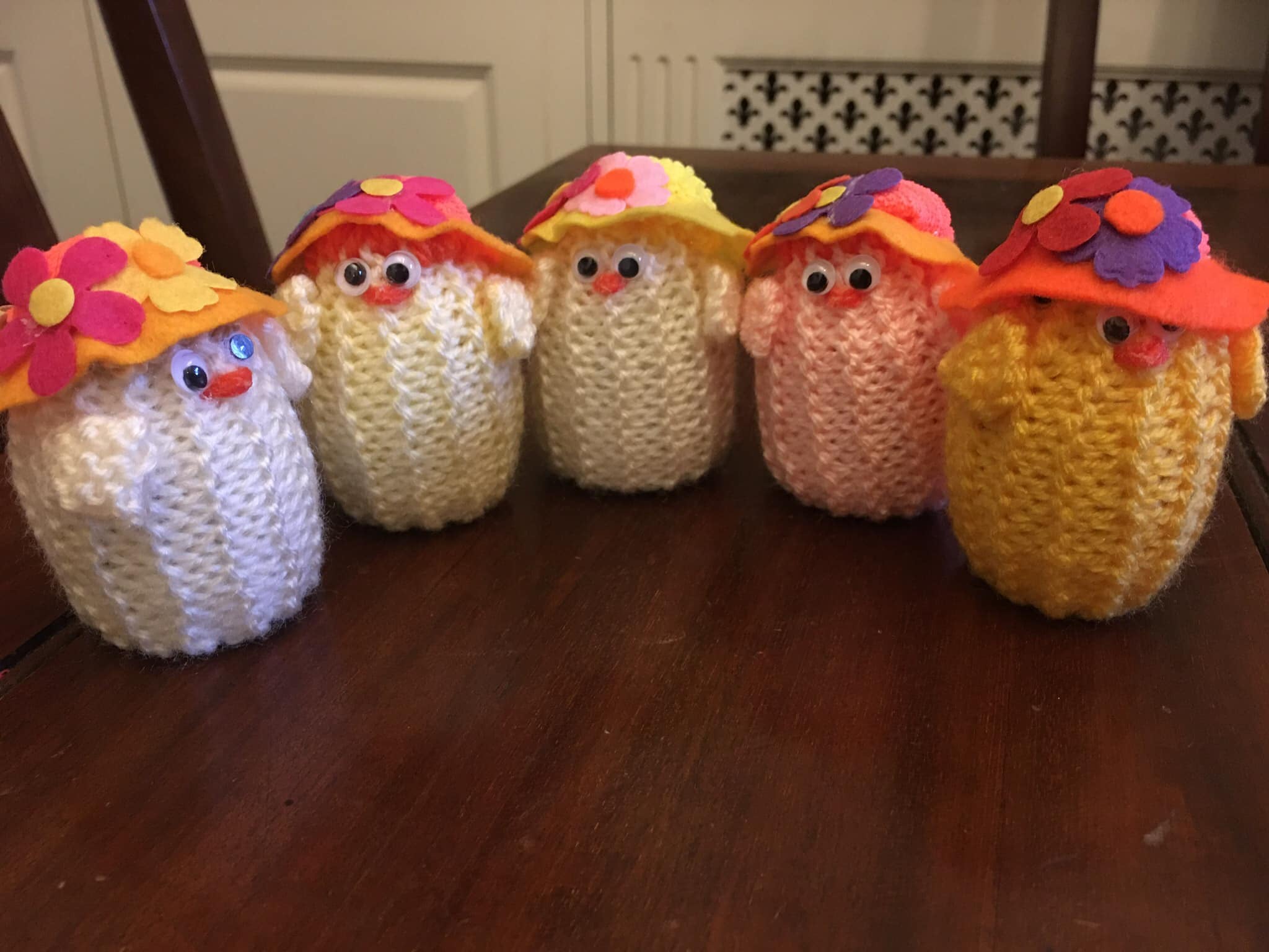 Five knitted Easter chicks wearing sunhats, made by Barbara Baldwin 