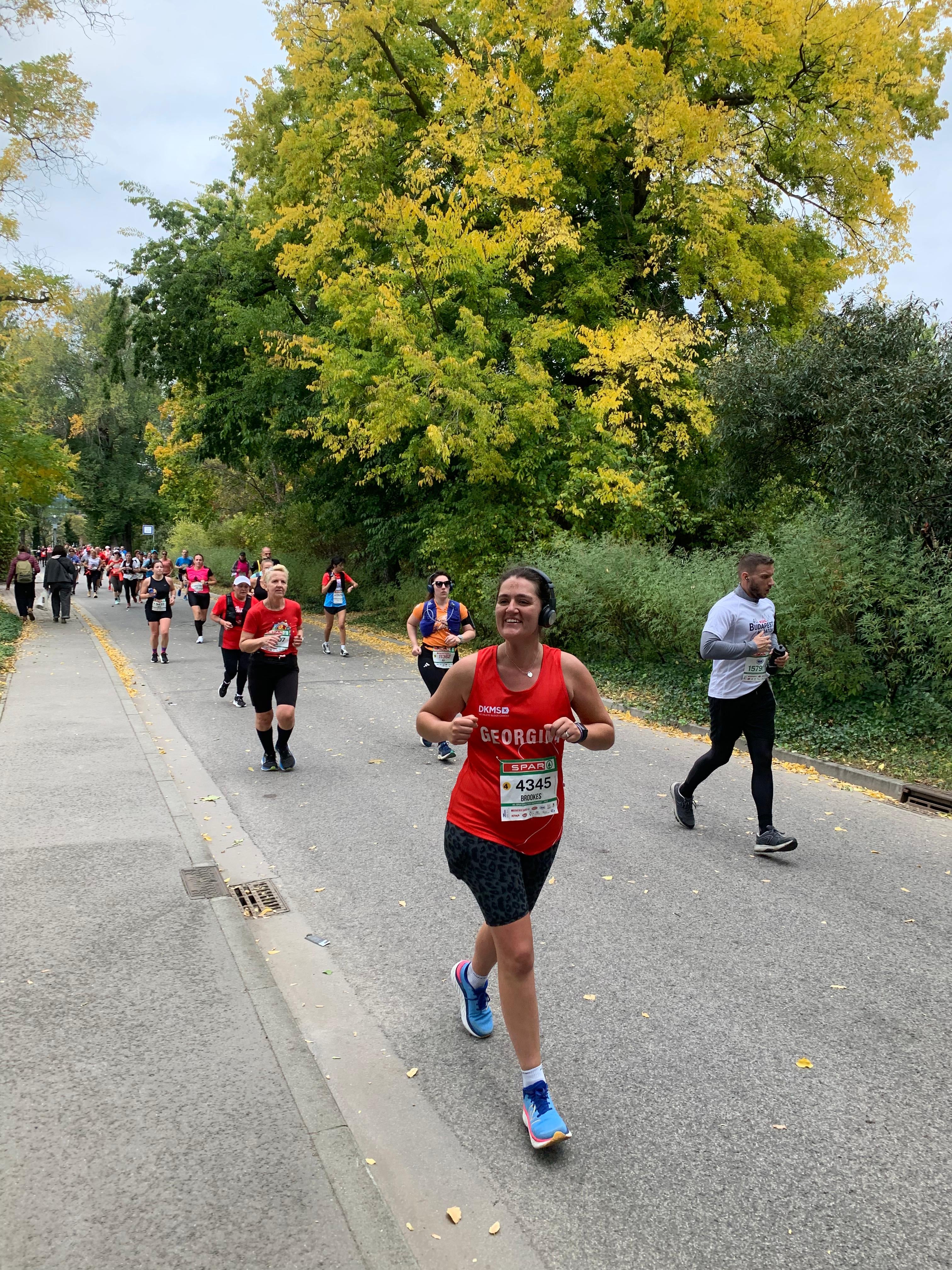 Woman running in a DKMS vest