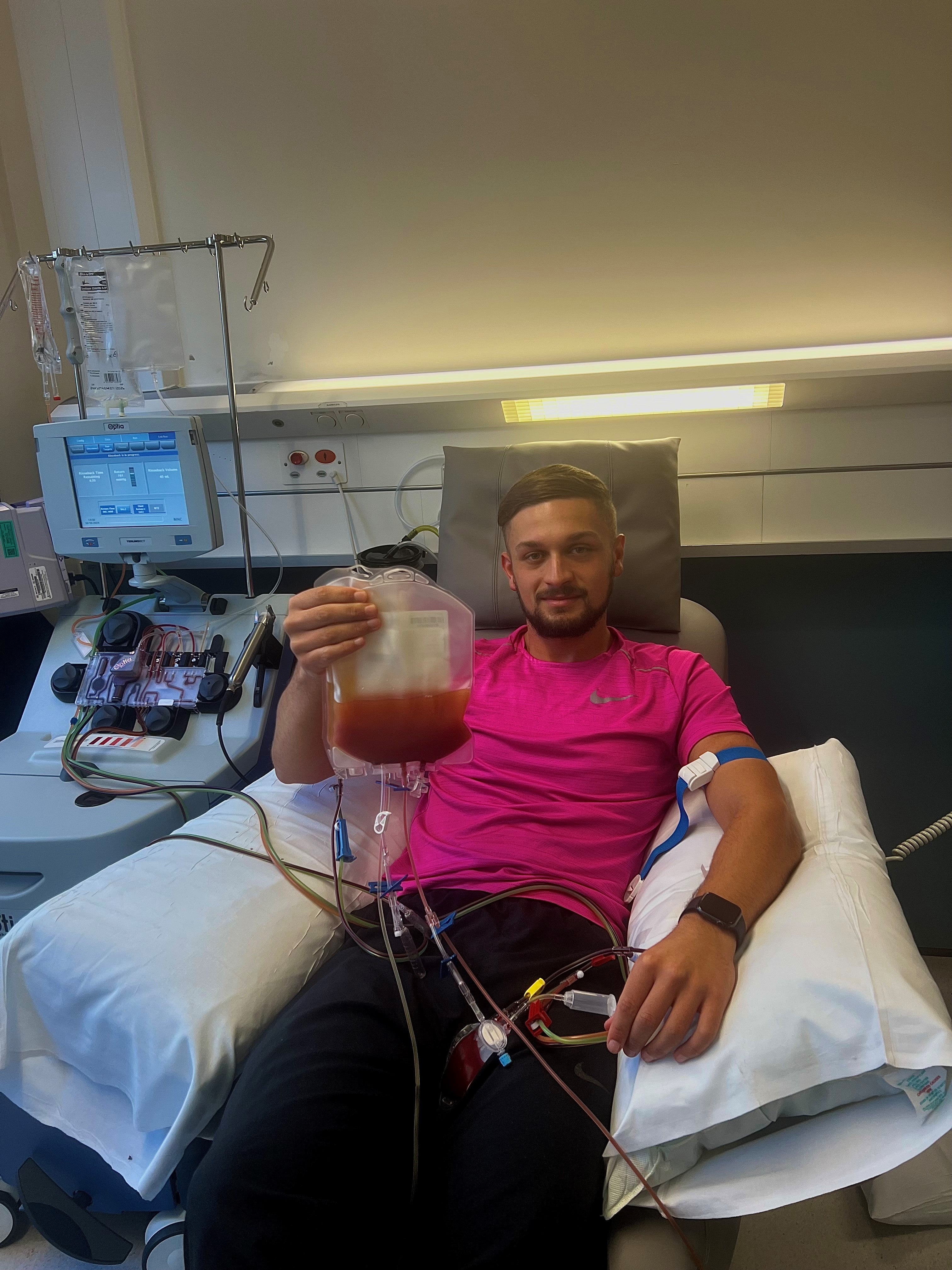 Middle age man on a hospital bed holding a bag of stem cells