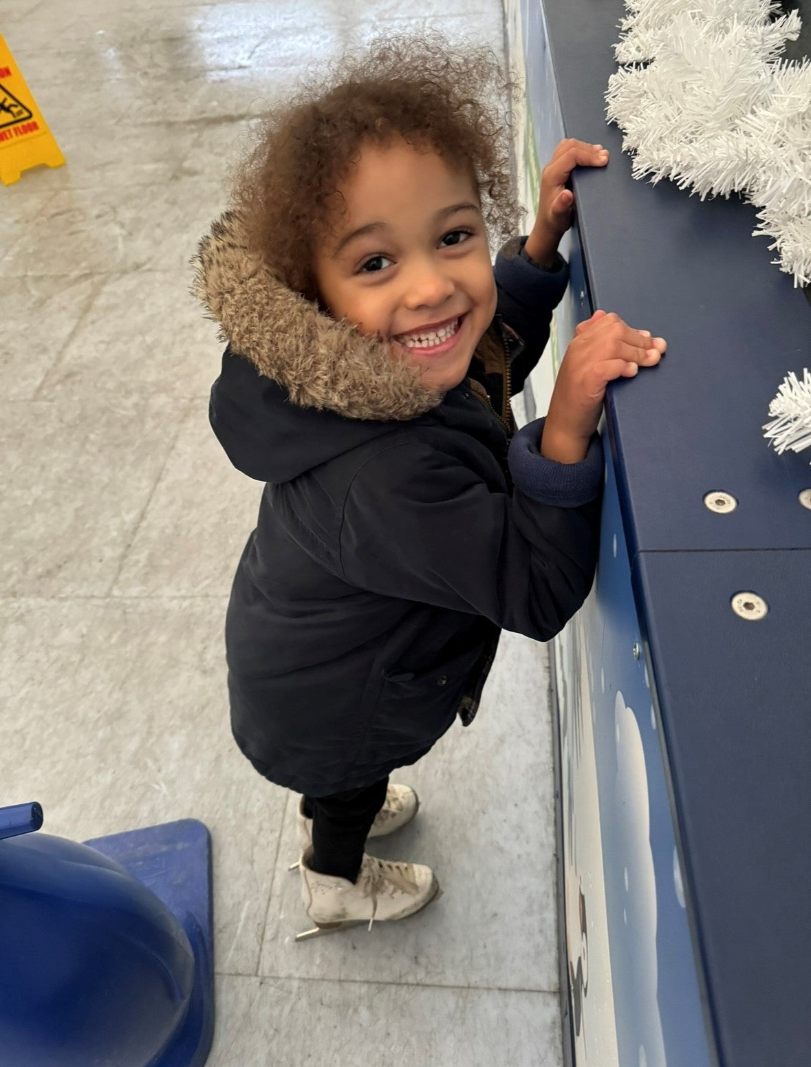Little boy smiling with Ice boots