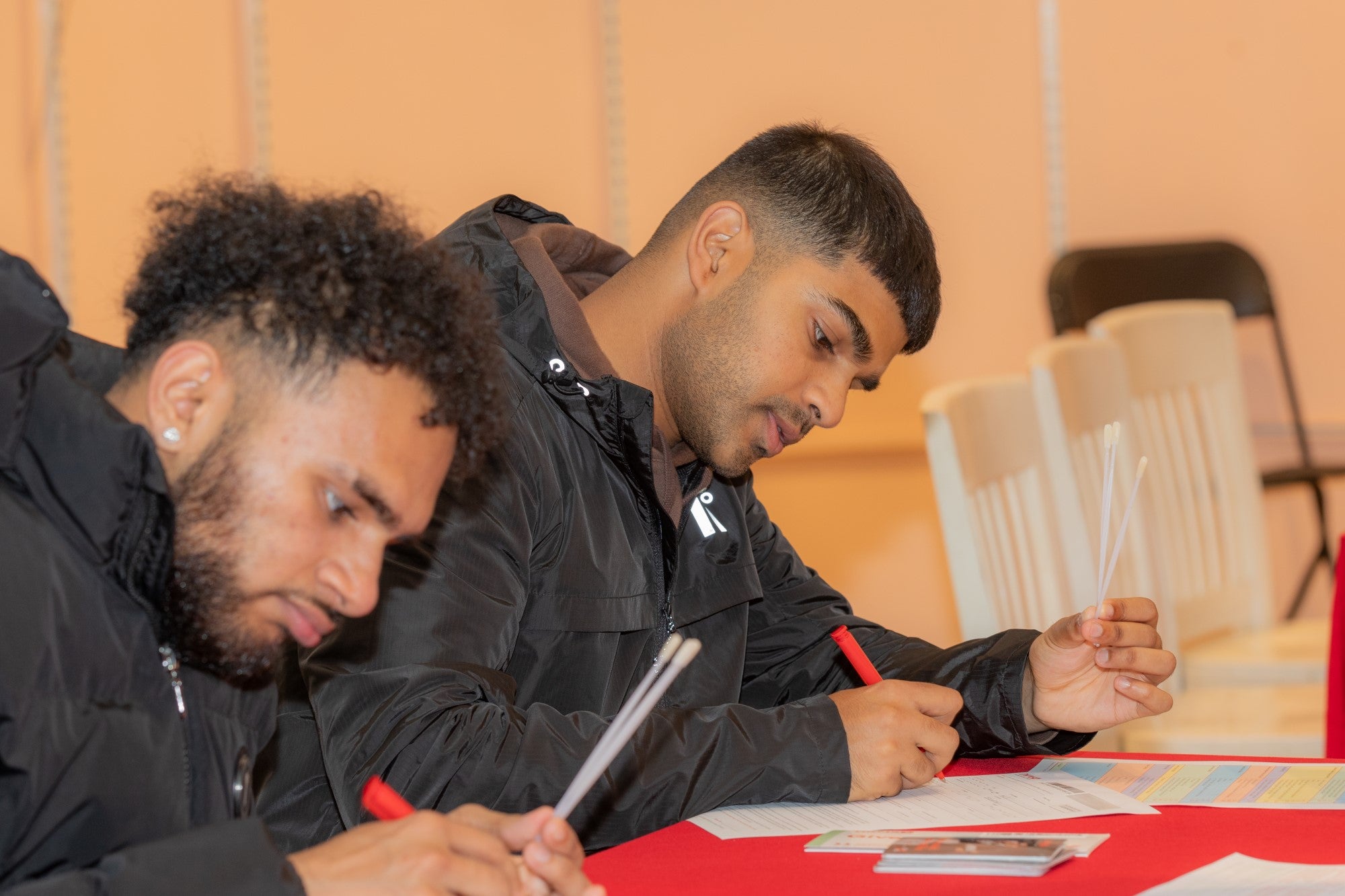 Two Asian men registering 