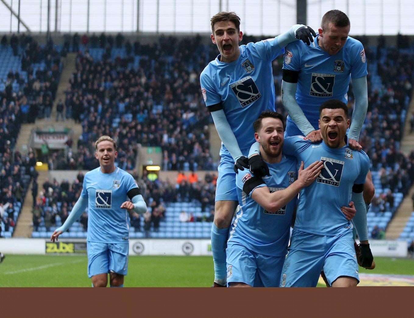 Jubilent Coventry City players celebrate goal Against Swindon Town 